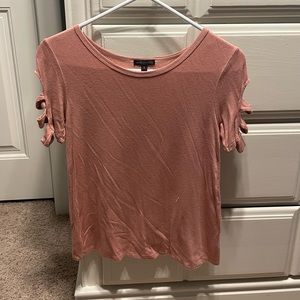 Light pink tee with cut outs in the sleeves